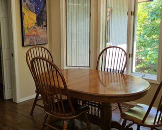 solid oak table with six chairs, two captain four straight back extra leaves and pad 400.00