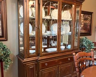 Cherry breakfront with broken pediment top and beveled glass and carved glass doors