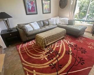 Sectional couch, ottoman, decorative rug, side table & lamp