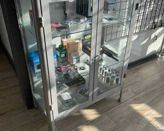 Miscellaneous small bike items and glass display cabinet, can be purchased separately
