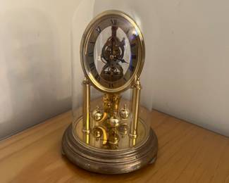 Petite brass Howard Miller kundo Germany open mechanism table top clock.