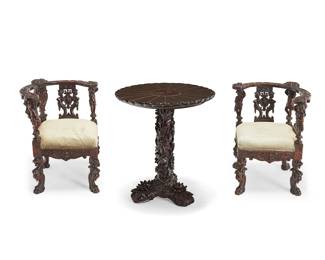2238
A Japanese carved wood table and pair of Baroque-style corner armchairs
19th century
Comprising a Japanese rounded pedestal table with floral medallion top above a standard tripartite base intricately carved with floral motifs in high relief, together with a pair of open corner chairs, each with figural supports and paw feet, the seats with light green upholstery and brass tacking
3 pieces
Table: 30" H x 26" Dia.; Each chair: 30.5" H x 21" W x 21" D
Estimate: $600 - $900