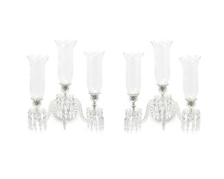 2415
A pair of Baccarat glass three-light sconces
Mid/late 20th century
Each with Baccarat factory stencil mark
Each curving arm issuing from circular backplate and ending in vasiform nozzles and scalloped bobèches hung with faceted prisms, fitted with etched hurricane shades
2 pieces
Each: 22.5" H x 18" W x 12.5" D
Estimate: $600 - $800
