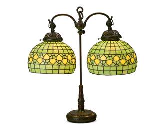 2097
A Tiffany Studios patinated bronze double student lamp, model 316
Early 20th century
Impressed on underside: Tiffany Studios / New York / 316
With two adjustable articulated swing arms, together with two associated reproduction leaded glass geometric shades
Without shades: 26.5" H x 19.5" W x 7.125" D; Each shade: 8" H x 11.5" Dia.
Estimate: $2,000 - $4,000