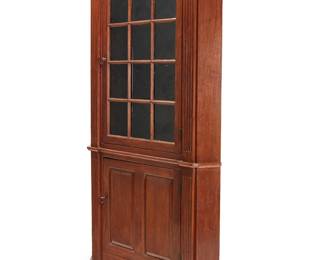 2428
A Chippendale stained wood corner cupboard
Late 18th century
With an architectural cornice above a glazed locking cabinet door revealing three shelves, flanked by fluted accents, above a lower locking cabinet door revealing a single shelf, raised on bracket feet, together with an associated document depicting the the family tree and history of this piece
93" H x 50" W x 22" D
Estimate: $600 - $800