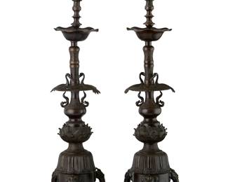 2351
A pair of Japanese bronze candlesticks
20th century
Each single-light candleholder with scalloped rim wax catcher above two crane figures joined by floral openwork, the standard with chased decorations
2 pieces
Each: 34.75" H x 9" W x 9" D
Estimate: $700 - $900