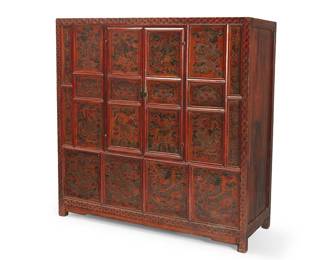 2300
An Asian lacquered wood cabinet
Possibly Tibetan, 20th century
The red lacquered cabinet with painted decorations depicting various figures including phoenixes, dragons, and other mythical beasts, featuring two hinged cabinet doors revealing two drawers centering open cavities
58.5" H x 59.25" W x 21" D
Estimate: $500 - $700
