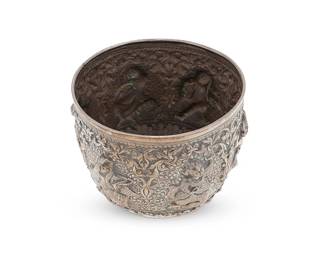 2282
A Burmese sterling silver bowl
20th century
Unmarked
The round vessel with elaborate chased and repoussé scrolled motifs surrounding haute-relief cartouches of dancing figures
4" H x 5.25" Dia.
9.1 oz. troy approximately
Estimate: $700 - $900