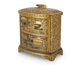2069
A Japanese Komai-style damascened miniature kodansu
Meiji period or later
Unmarked
The gold-inlaid iron and brass diminutive cabinet with three drawers raised on bracket feet and surmounted by a ring loop handle, each drawer front depicting a village landscape scene, the surrounding surfaces bearing leaf motifs
3.625" H x 3.25" W x 2.25" D
Estimate: $1,000 - $1,500