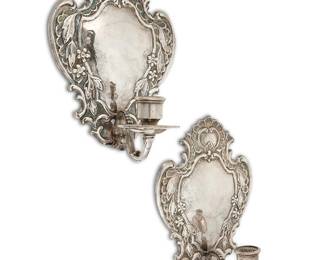 2236
A pair of Baroque-style silver-plated wall sconces
Early 20th century
Each unmarked
Each single-light sconce with repoussé scrolled, foliate, and floral motifs, issuing a foliate-form arm
2 pieces
Each: 10.875" H x 8.375" W x 5.75" D
Estimate: $500 - $700
