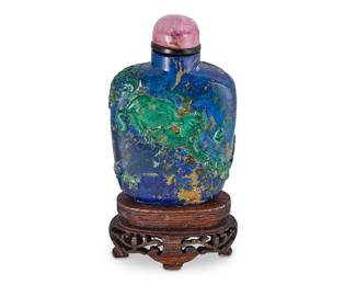 2147
A Chinese carved azurmalachite snuff bottle
Late 19th century
Carved with cat figures to each side and mounted on a carved wood stand
Overall: 3.5" H
Estimate: $300 - $500