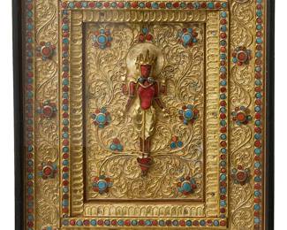 2127
A Nepalese stone-inset gilt filigree votive plaque
Early/mid-20th century
The rectangular panel with a central deity on an ornate gilt scrolling filigree ground mounted with coral and likely glass cabochons
Sight: 9.75" H x 7.875" W
Estimate: $1,800 - $2,000