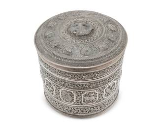 2285
A Burmese sterling silver betel nut box
20th century
Appears unmarked
The round vessel with elaborate chased and repoussé scrolling vine motif surrounding cartouches of various animals, the lid with a haute-relief figural medallion
6" H x 6" Dia.
19.5 oz. troy approximately
Estimate: $700 - $900