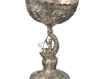 2003
A German sterling silver figural compote
Late 19th/early 20th century
With German hallmarks for .800 silver, but XRF tested between .915 and .940 purity; marked for unknown maker: B / [lion passant] / [crown] / 800 / [illegible]
The shell-form bowl with repoussé decoration depicting figures riding dolphins in the sea, raised on a figural standard dolphin and rider holding a trident with reins, on a conforming repoussé foot
10.625" H x 5.75" W x 4.875" D
15.7 oz. troy approximately
Estimate: $600 - $800