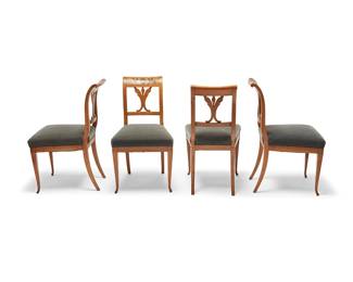 2404
A set of four Biedermeier dining chairs
Early/mid-19th century
Each with a straight top rail with marquetry griffins flanking a shield, over a foliate back splat and grey upholstered seat with brass tacking, raised on four splayed legs
4 pieces
Each: 33.25" H x 18" W x 23" D
Estimate: $500 - $700