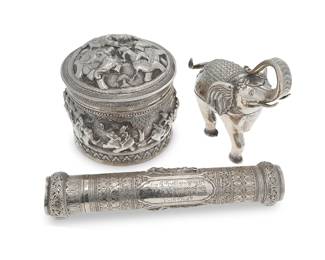 2278
A group of Burmese silver items
20th century
The manuscript holder with an inscription in Burmese
Comprising a round, lidded sterling silver box with chased and repoussé haute-relief elephant motifs, a sterling silver manuscript holder with chased and repoussé figural motifs, and a silver alloy elephant-form box
3 pieces
Round box: 7" H x 7.5" Dia.; Elephant: 8" H x 7.75" W x 5" D; Manuscript holder: 13.25" L x 3" Dia.
Total weight: 61.2 gross oz. troy approximately
Estimate: $600 - $800