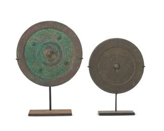 2317
Two Chinese bronze mirrors
Warring States through Han Dynasty (475 BCE-220 CE) or style
Each circular mirror with central knop surrounded by stylized scrolls or geometric motifs, set in an enameled metal stand
2 pieces
Larger mirror: 6.25" Dia. Smaller mirror: 5.25" Dia.; Larger overall: 8.875" H
Estimate: $800 - $1,200