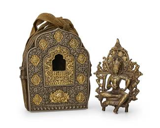 2126
An Asian reticulated metal ga'u and figure of Vajrasattva
19th century or later; Tibet or greater Vajrayana Diaspora
With the seated deity figure in brass-toned metal and accompanying shrine case with gold-toned accents wrapped in cloth
2 pieces
Figure: 6.875" H x 5" W x 1.875" D; Case metal: 7.75" H x 7" W x 2.875" D
Estimate: $1,000 - $1,500
