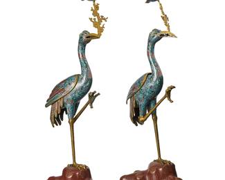 2139
A pair of East Asian cloisonné crane candlesticks
20th century
Each bird with hollow body and removeable wings, raising a tree branch-form standard with a conformingly enameled bobèche, all raised on a rock-form triangular base set in a wood stand
2 pieces
Each overall: 37.25" H x 13" W x 13" D; Each without branch: 28.25" H
Estimate: $1,000 - $2,000