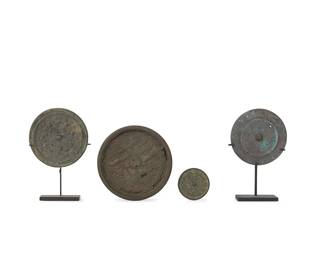 2322
A group of Chinese bronze mirrors
Warring States through Han Dynasty (475 BCE-220 CE) or style
The largest cast with clouds, two cranes, and a turtle knop, the next with frog knop surrounded by creatures and symbols, the third with scrolls, and the smallest with symbols and script, two set on enameled metal stands
4 pieces
Largest: 4.875" Dia.; Smallest: 2" Dia.
Estimate: $1,200 - $1,800