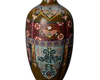 2062
An East Asian cloisonné vase
20th century
Unmarked
The polychrome enameled copper footed vase with a lobed body below a long flared neck, depicting butterfly and phoenix figures on a floral and filigree ground
12.125" H x 5.25" Dia.
Estimate: $300 - $500