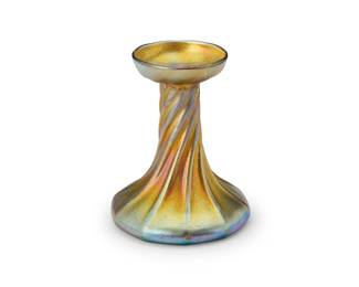 2095
A Tiffany Studios Favrile glass candlestick base
Circa 1902-1918
Etched to underside: L. C. T.; further etched: 4988
The iridescent gold glass candlestick with twisted form
5.25" H x 4.25" Dia.
Estimate: $400 - $600