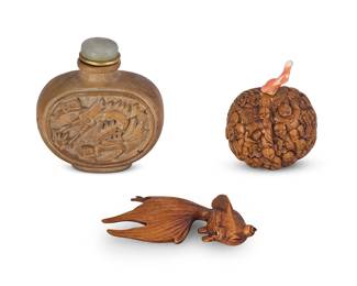 2143
Three East Asian carved items
Early/mid-20th century
Goldfish with incised signature
Comprising a Chinese carved wood bottle, a Chinese carved walnut bottle with coral stopper, and a Japanese carved goldfish okimono
3 pieces
Larger bottle: 2.75" H; Okimono: 3.125" L
Estimate: $300 - $500