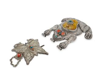 2290
Two Southeast Asian sterling silver ornaments
20th century
Each appear unmarked
Each with chased and repoussé decoration, comprising a large frog pendant centering a large yellow stone set with a smaller turquoise, and with turquoise and coral stone to the face, along with a butterfly hair barrette set with coral and turquoise
2 pieces
Frog: 10" H x 9.5" W x 3" D; Butterfly: 5.25" H x 6.5" W x 1.5" D
Total weight: 48.3 gross oz. troy approximately
Estimate: $400 - $600