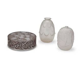 2106
Three René Lalique glass vessels
Early 20th century
Roger wheel-cut: R LALIQUE / FRANCE; further etched: 121-8; Eglantines with etched signature: R Lalique; Perles wheel-cut: R LALIQUE
Comprising a 'Roger' powder box (designed 1926) with painted grape and avian motifs, an iridescent glass 'Eglantines' vase, and an iridescent glass 'Perles' vase
3 pieces
Roger: 2" H x 5.5" Dia.; Eglantines: 4.375" H x 3" Dia.; Perles: 4.875" H x 3.25" Dia.
Estimate: $800 - $1,200