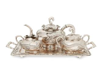 2001
A Chinese Export silver tea service
Late 19th/early 20th century
Three vessels marked: Cheong Shing; tray marked: KMS [Kwong Man Shing]
Each with repoussé dragons to body and bamboo-form handles and spouts, comprising a Cheong Shing tea pot with hinged lid (5.25" H x 9.5" W x 5.5" D), an open creamer (2.75" H x 5" W x 3.875" D), and a lidded sugar (4.125" H x 5.875" W x 4.375" D), set on a conformingly designed Kwong Man Shing rectangular handled tray (1.625" H x 15.25" W x 9.25" D)
4 pieces
56.6 oz. troy approximately
Estimate: $2,000 - $3,000