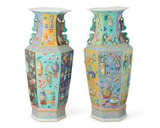2370
A pair of Chinese Famille Rose porcelain vases
20th century
Each of hexagonal form, with applied precious objects in relief and lion handles to the neck
Each: 22.5" H x 9.5" Dia.
Estimate: $800 - $1,200