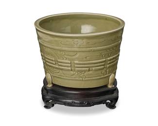 2193
A Chinese Longquan celadon censer
Yuan/Ming Dynasty (1271-1644) or later
The vessel with bagua decoration, raised on three feet and set on a custom carved wood stand
Vessel: 6.75" H x 10" Dia.; Stand: 2.5" H x 9.125" Dia.
Estimate: $1,500 - $2,000