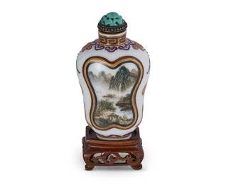 2154
A Chinese porcelain snuff bottle
Mid-19th century
Each side painted with a mountain scene, with carved turquoise stopper, mounted on a carved wood stand
Overall: 3.5" H
Estimate: $300 - $500