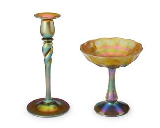 2093
A Steuben Aurene glass compote and candlestick
1920s
Each etched to underside: Steuben / Aurene; candlestick further etched: 686
The iridescent gold glass items, comprising a footed compote and a footed candlestick with twisted standard
2 pieces
Compote: 6.875" H x 6.375" Dia.; Candlestick: 10" H x 4.625" Dia.
Estimate: $250 - $350