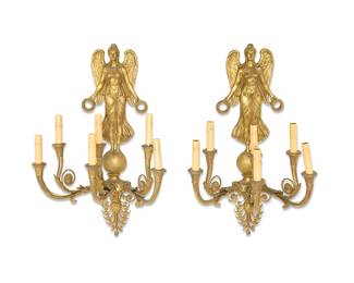 2255
A pair of Empire-style gilt-bronze wall sconces
20th century
Each six-light wall fixture with an upper angel figure holding a wreath in each hand above three double-arms with foliate accents above an elaborate palmette, electrified
2 pieces
Each: 29" H x 17.5" W x 13" D
Estimate: $500 - $700
