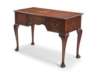 2269
A George II provincial-style oak writing desk
19th century
The wood desk with molded edges above three drawers with joinery and brass bulls, raised on cabriole legs with pad feet
31" H x 45" W x 21" D
Estimate: $400 - $600