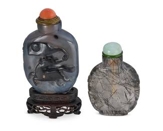 2169
Two Chinese carved stone snuff bottles
19th century
Comprising one agate snuff bottle carved with a horse figure in relief and mounted on a carved wood stand, and a black hair crystal snuff bottle
2 pieces
Taller overall: 3.5" H
Estimate: $300 - $500