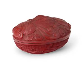 2316
A Chinese cinnabar-style lidded box
20th century
The carved wood box with red lacquer to exterior depicting a goldfish in relief to the lid and a roiling sea to the bottom, with black lacquered interior
3.5" H x 6.125" W x 4.5" D
Estimate: $300 - $500