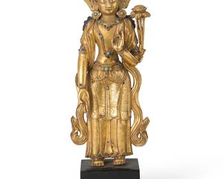 2303
A gilt-metal figure of Padmapani
Nepal or greater Himalayan/Vajrayana diaspora, 14-15th century or style
The copper alloy figure with skirts chased with cloud and floral motifs, mounted with turquoise, garnets, and glass, on a wooden stand
Figure: 10.5" H x 4.5" W x 2.375" D; Overall: 12.5" H
Estimate: $3,000 - $5,000