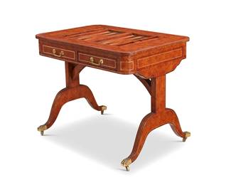 2418
A Maitland-Smith Regency-style leather-clad games table
Late 20th century
The leather-wrapped wood table with gilt and blind stamped borders, featuring an inset backgammon board, each side with one drawer and one false-front, raised on stylized trestle supports joined by an arched stretcher and terminating in brass paw feet with casters, together with assorted game pieces
29" H x 26" W x 37" L
Estimate: $400 - $600