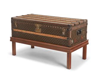 2102
A Louis Vuitton steamer trunk on later stand
Circa 1930s-1940s
Serial number: 811670; with orange and gold foil label to interior
With LV monogram canvas wrapped exterior and wood slats to the lid and body, the interior with jacquard branded strapping and brass tacking, and with iron hardware and lockplates, on a later-added wood stand
Trunk: 13" H x 43.5" W x 1.5" D; On stand: 25" H
Estimate: $3,000 - $5,000
