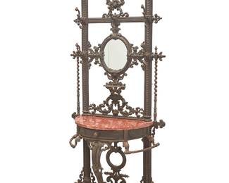 2384
A Victorian cast-iron hall tree
19th century
Possibly Coalbrookdale, the backing with scroll motifs and opposed barley twist accents centering an oval mirror, featuring a single drawer and a demilune marble top
86" H x 38" W x 16" D
Estimate: $500 - $700