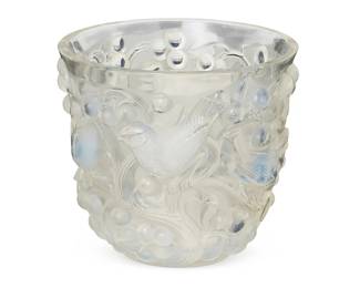 2105
A René Lalique glass 'Avallon' vase
Marcilhac 986, design introduced 1927
Wheel-cut: R LALIQUE / FRANCE; further etched: N: 986
The molded iridescent glass vase with birds amidst clusters of grapes in medium relief
5.75" H x 6.5" Dia.
Estimate: $400 - $600
