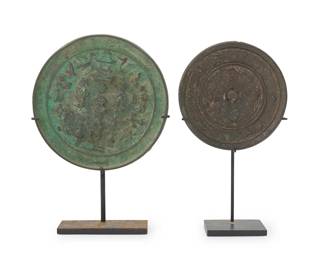 2318
Two Chinese bronze mirrors
Tang/Song Dynasty (618-1279) or style
The larger cast with a building, figures, and birds, the smaller with running animals, each set in an enameled metal stand
2 pieces
Larger: 5.25" Dia.; Smaller: 4.25" Dia.; Larger overall: 7.75" H
Estimate: $1,000 - $1,500