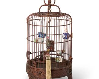 2312
A Chinese carved wood bird cage
Qing Dynasty (1644-1912) or later
The base and upper portions carved with fish, crabs, and aquatic motifs, with applied carved wood and bone elements, some which are supporting interior porcelain bowls, surmounted by an enameled metal finial and metal hook, accented by a figural beaded charm with fabric tassels
24.25" H x 10.5" Dia.
Estimate: $300 - $500