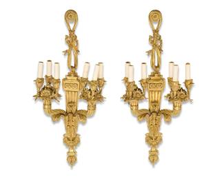 2252
A pair of Louis XVI-style gilt-bronze appliques
20th century
Each six-light wall fixture with an upper medallion draped in ribbons above a fluted standard issuing two three-light arms with faux candle lights and floral and foliate motifs, electrified
2 pieces
Each: 35" H x 14.5" W x 8.5" D
Estimate: $700 - $900