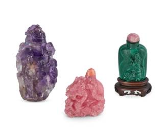 2167
Three Chinese carved stone snuff bottles
Late 19th/20th century
Comprising one malachite carved with a figure and guardian lion and mounted on a wood stand, one amethyst carved with a maiden figure in haute relief, and one rhodocrosite carved with a dragon figure
3 pieces
Tallest: 4" H
Estimate: $400 - $600