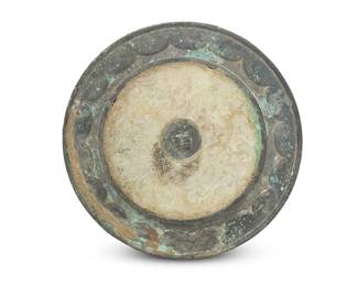 2323
A Chinese bronze mirror with unusual jade inlay
Han through Tang Dynasty (206 BCE-907 CE) or style
The exterior of the jade disc carved in raised relief in a densely composed ground of stylized zoomorphic repeating chilong patterns, the bronze border with petal forms
9.25" Dia.
Estimate: $2,500 - $3,500