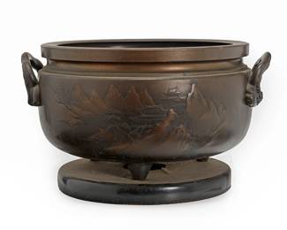 2348
A large Japanese bronze planter
20th century
The planter with opposed dragon-form handles and chased decorations to body depicting a mountain village scene, raised on tripod feet and mounted to a conformingly patinated metal and wood base
16" H x 22" Dia.
Estimate: $300 - $500