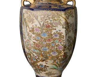 2070
A Japanese Satsuma pottery vase
20th century
The footed vase with hexagonal body and flat shoulder, opposed handles below a flared neck, featuring painted and gilt avian and floral motifs within a landscape scene, and gilt details on a cobalt ground
14.5" H x 7.75" W x 7.25" D
Estimate: $300 - $500